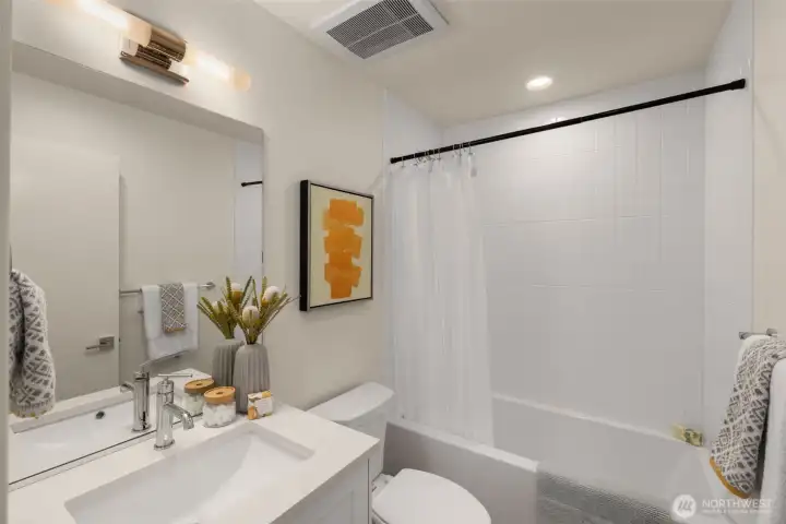 The bathroom has a full-sized tub