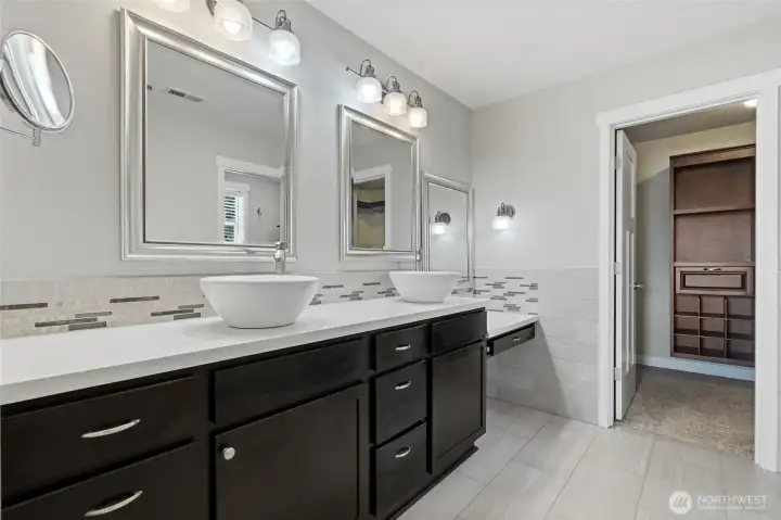 Primary Bathroom with luxury tile artistry, a lady-dressing sitting area, and a walk-in closet with a cherry-wood built-in, all providing you with privacy. Primary Bathroom with luxury tile artistry, a lady-dressing sitting area, and a walk-in closet with a cherry-wood built-in, all providing you with privacy.