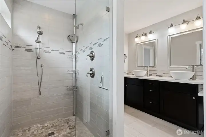 The primary bathroom with luxurious tile artistry is completely perfected. The primary bathroom with luxurious tile artistry is completely perfected.