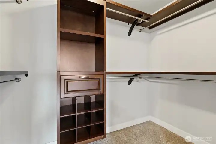 Walk-in closet with a cherry-wood storage furnishing, all providing you with privacy. Walk-in closet with a cherry-wood storage furnishing, all providing you with privacy.