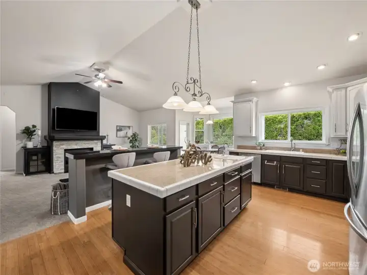 Spacious vaulted kitchen and living room blend together beautifully, highlighted by an additional breakfast bar for casual dining or entertaining. Spacious vaulted kitchen and living room blend together beautifully, highlighted by an additional breakfast bar for casual dining or entertaining.