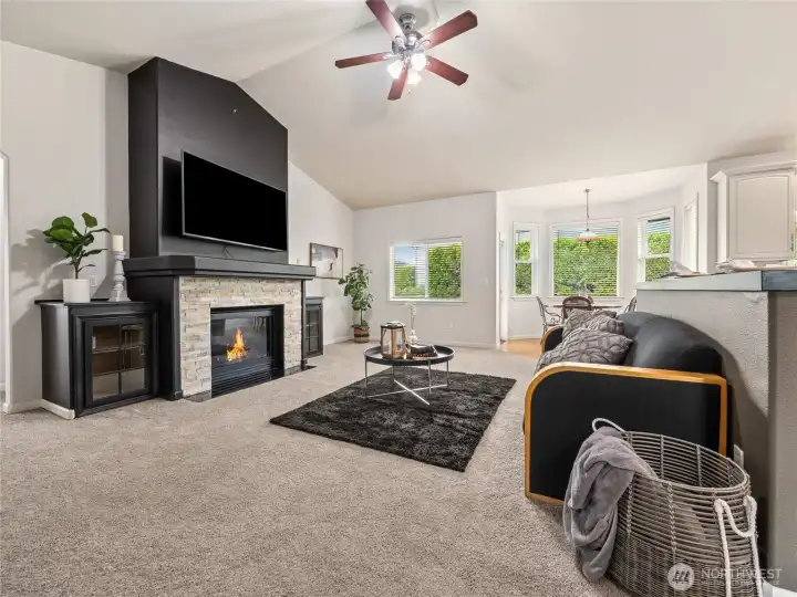 Expansive living room with soaring ceilings and a cozy gas fireplace as an inviting focal point. Expansive living room with soaring ceilings and a cozy gas fireplace as an inviting focal point.