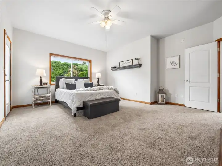Serene and spacious primary retreat featuring patio access, a private ensuite, and a custom walk-in wardrobe. Serene and spacious primary retreat featuring patio access, a private ensuite, and a custom walk-in wardrobe.
