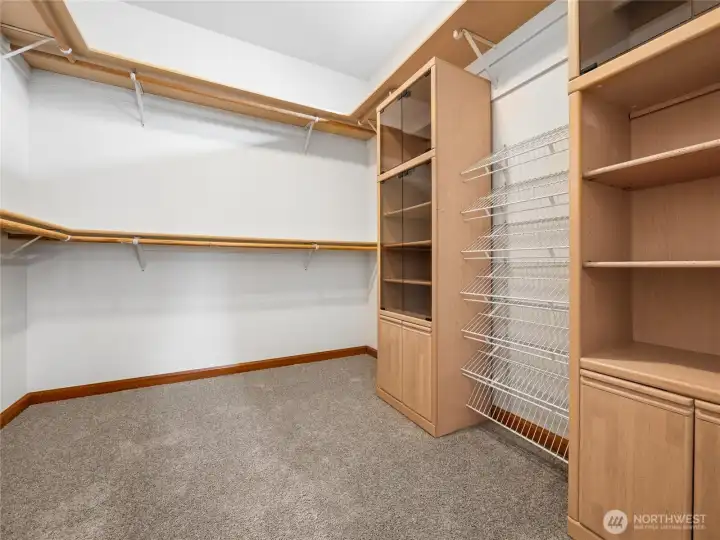 Generously sized walk-in wardrobe with custom built-ins, shelving, and storage designed for effortless organization. Generously sized walk-in wardrobe with custom built-ins, shelving, and storage designed for effortless organization.