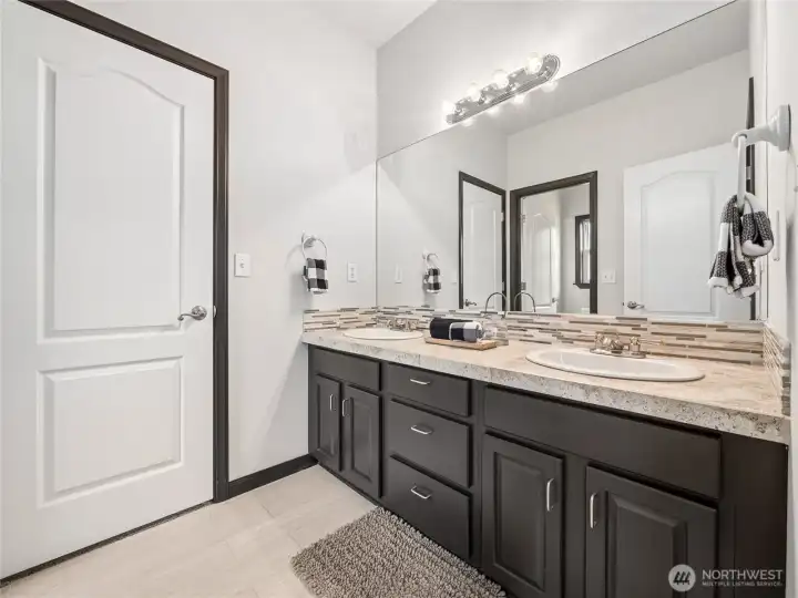 Smartly configured Jack and Jill bathroom connecting two bedrooms, offering a private toilet and separate tub/shower section. Smartly configured Jack and Jill bathroom connecting two bedrooms, offering a private toilet and separate tub/shower section.