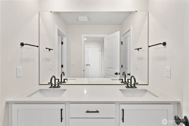Upstairs bath. Photos of a previously completed home. Actual colors and finishes may vary. See site agent for details.