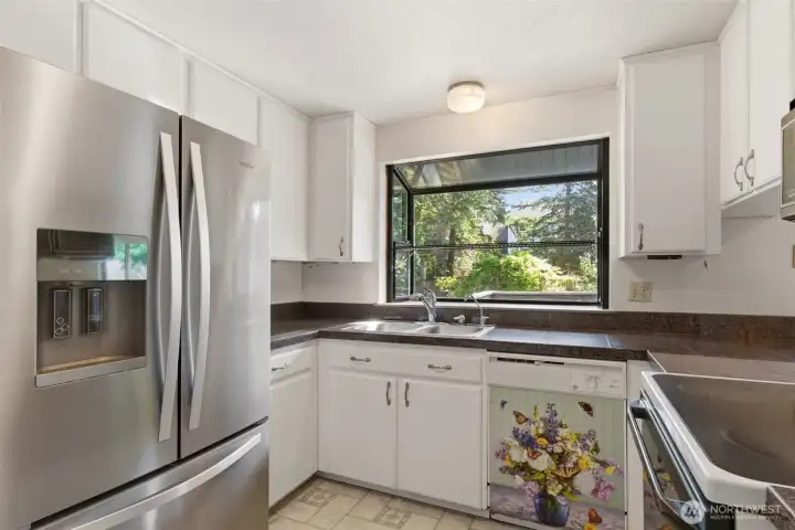Kitchen window looks out to the private backyard.