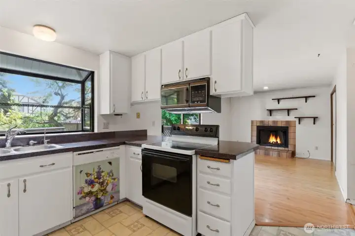 The kitchen opens to a family room space with cozy fireplace.