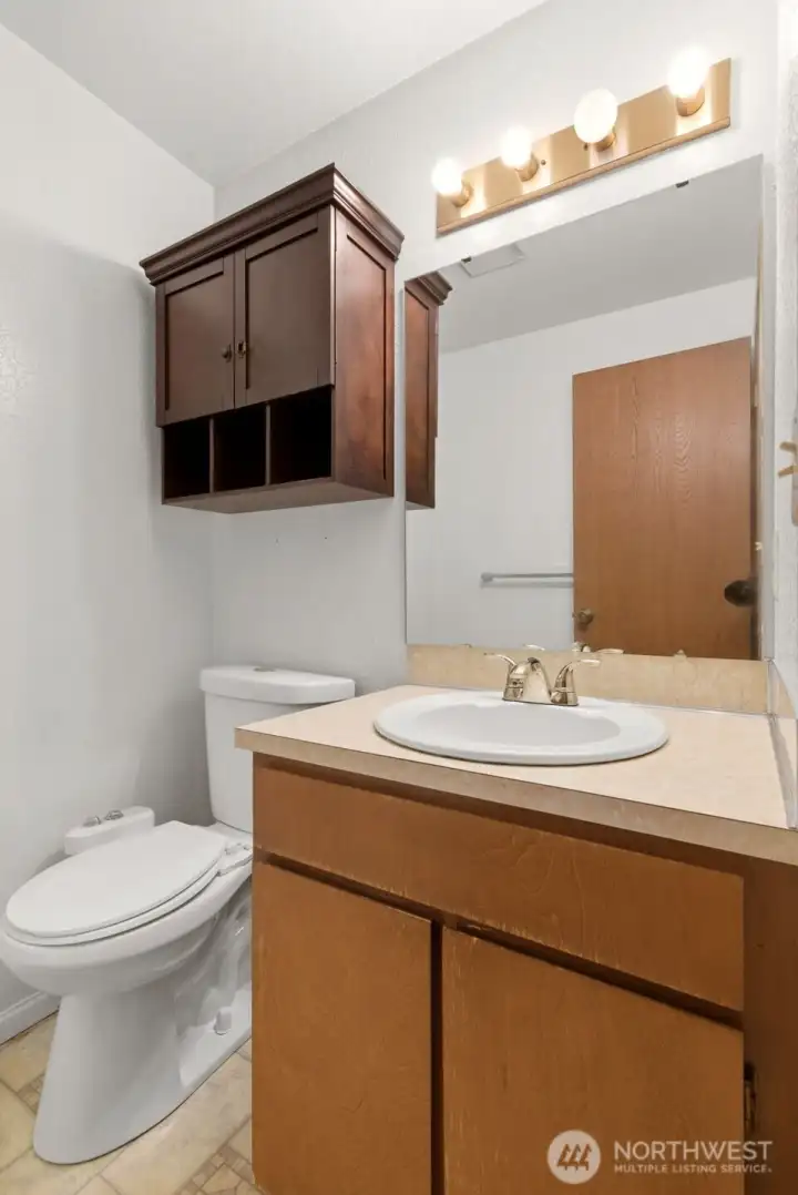 Located between the family room and garage is the powder room.