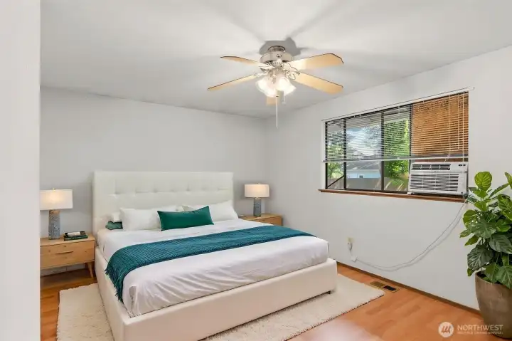 At the opposite end of the home is the primary bedroom, shown here virtually staged.