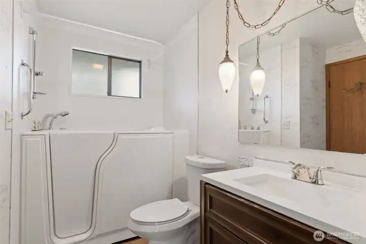 This bathroom has been outfitted with a safe, walk in bathtub.