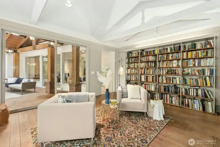 Library also features built in bookcase and oversized sliders leading to covered back patio