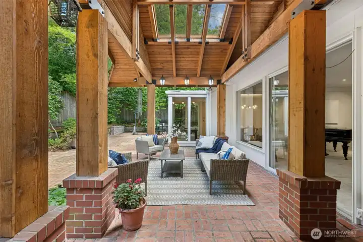 Another view of the covered back patio from the library / den, looking across into the sunroom.