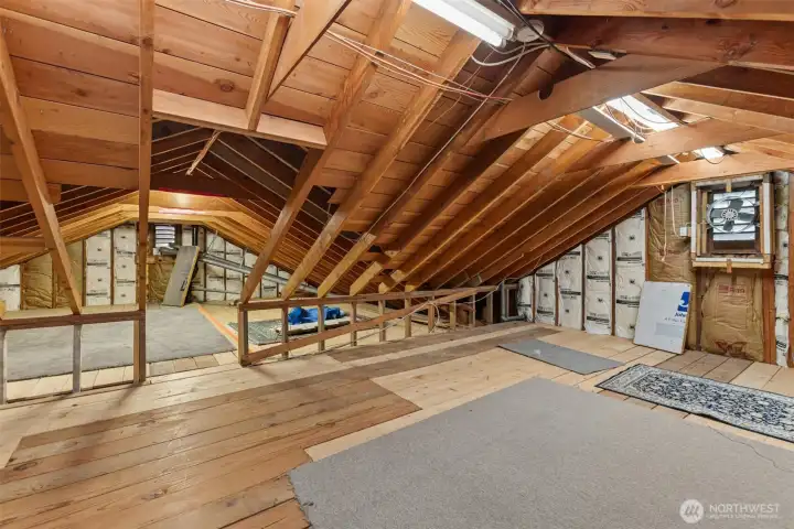 Unfinished attic space with ample amounts of storage