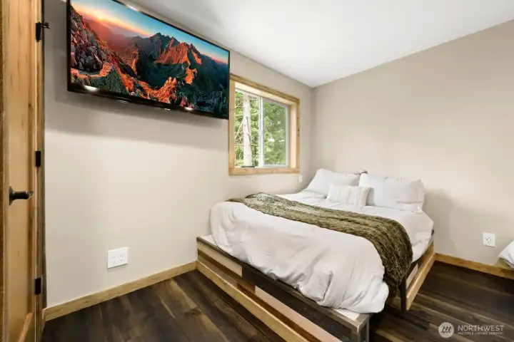 Designed with comfort in mind, the bunk room begins with a private queen sleeping area; ideal for guests who prefer a little extra space while still being part of the fun. Designed with comfort in mind, the bunk room begins with a private queen sleeping area; ideal for guests who prefer a little extra space while still being part of the fun.