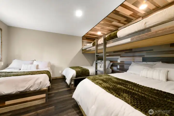 Built for unforgettable weekends at the lake, this expansive bunk room comfortably accommodates everyone, making it easy to gather friends and loved ones under one roof. Built for unforgettable weekends at the lake, this expansive bunk room comfortably accommodates everyone, making it easy to gather friends and loved ones under one roof.