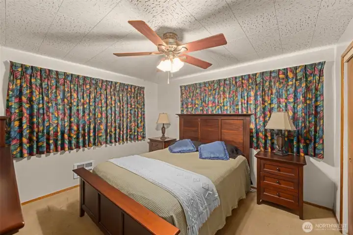 Second bedroom with tongue-and-groove wood paneled ceilings and a classic mid-century feel. Second bedroom with tongue-and-groove wood paneled ceilings and a classic mid-century feel.