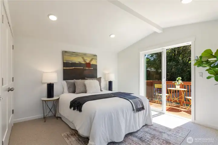 Primary bedroom upstairs with deck overlooking yard Primary bedroom upstairs with deck overlooking yard