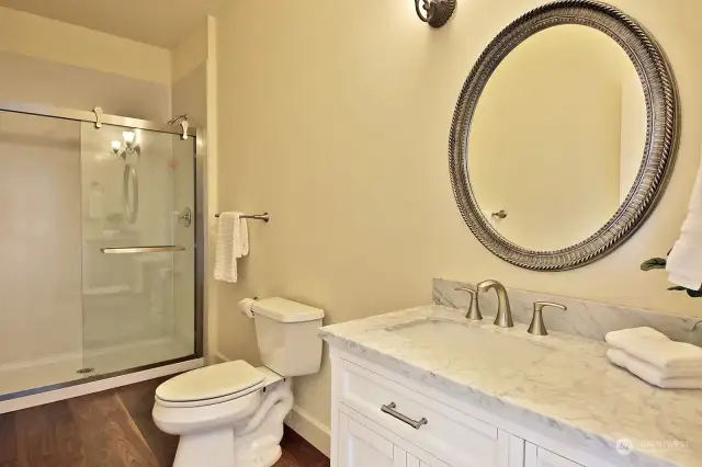 3/4 Main level bath with newly installed shower. Marble countertops.