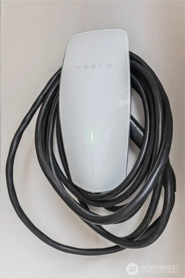 Tesla charger for electric car stays with the home