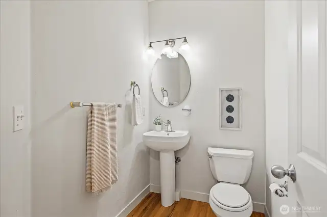 Main-level Powder Bath with a pedestal sink.