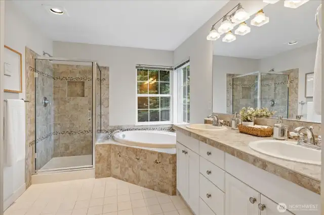 Primary Bathroom feels like a spa! Bathroom is appointed with dual vanities, a large soaking tub and separate shower space.