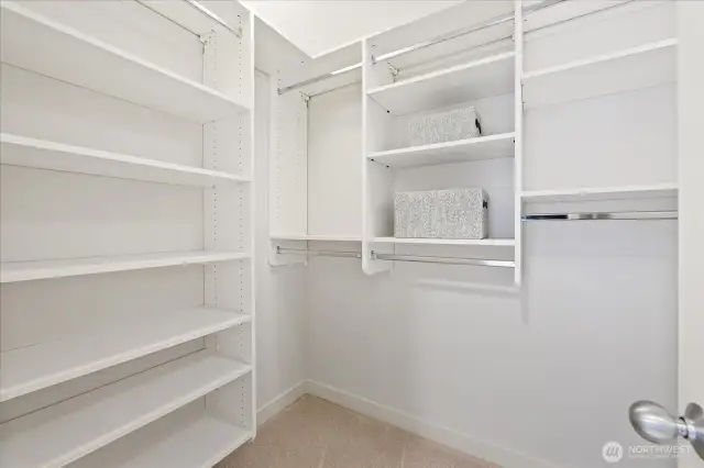 Closet system in the walk-in closet provides for efficient storage options.