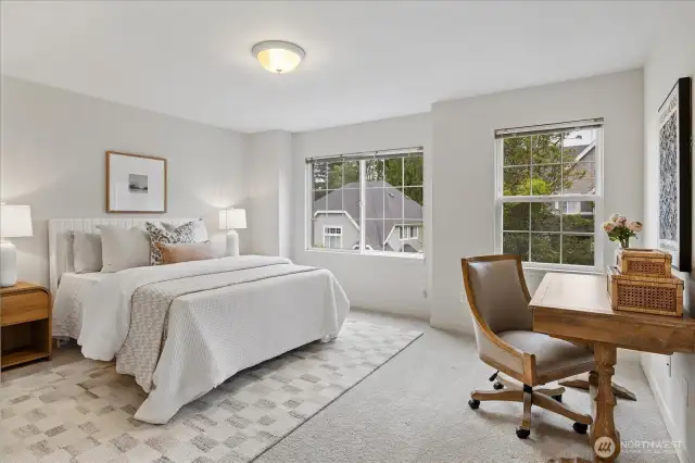 Spacious, light-filled guest bedroom with territorial views!