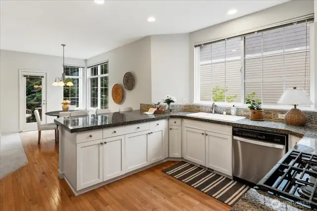The coveted white Kitchen with granite countertops and sparkling stainless steel appliances. Newer oven in the home.