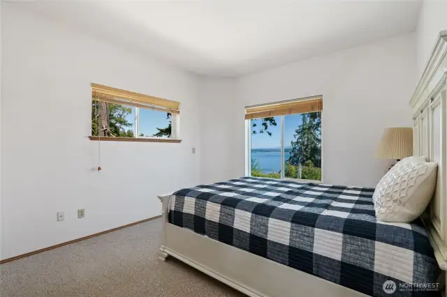 Main floor bedroom is large, bright & has an amazing water & mountain view.