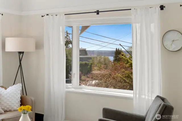 There are partial views of the sound out this window in the living room, you can see the ferry crossing to Vashon.