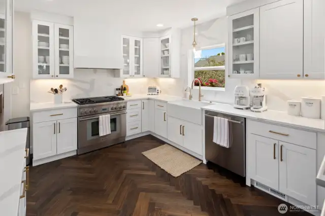 There is a Thermador 6-burner gas stove, quartz counters and cabinets with glass fronts for displaying your dishes and glassware.