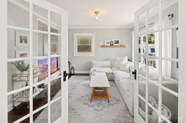 There are French doors into this family/bedroom from the living room as well as a regular door from the hallway.