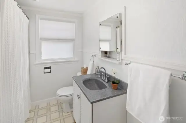 This is the full bath on the main floor.  It has the original mirror/storage cabinet over the sink.
