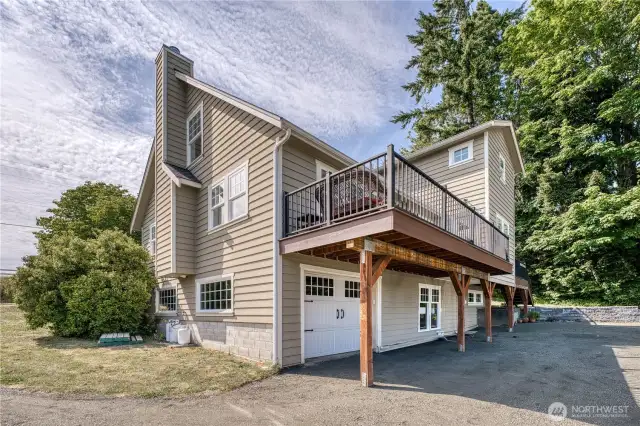 All of the decks are new, the door below is a one car garage, there is also a detached two car garage and shop.
