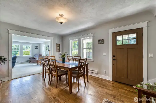 Entering the home, you are greeted by a large dining room with hardwood floors.