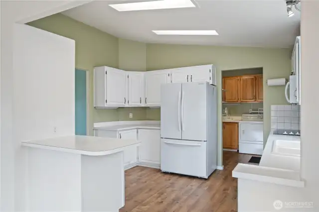 Just off the kitchen is the laundry room and access to the garage