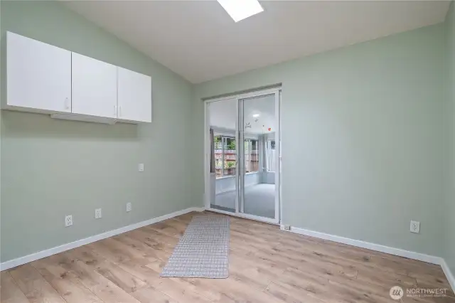 Bonus room, sliding doors lead to an enclosed porch