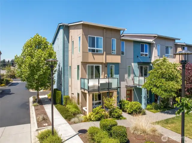Premium corner unit with quiet street entry, lush landscaping, and direct access to private park.
