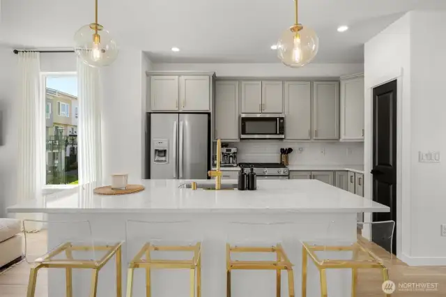 Bright kitchen with large island, open to dining