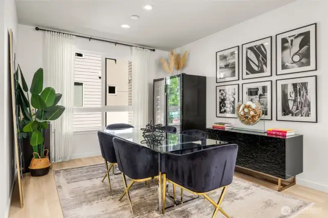 Dining space with natural light, flows to kitchen. Powder room and pantry off side.