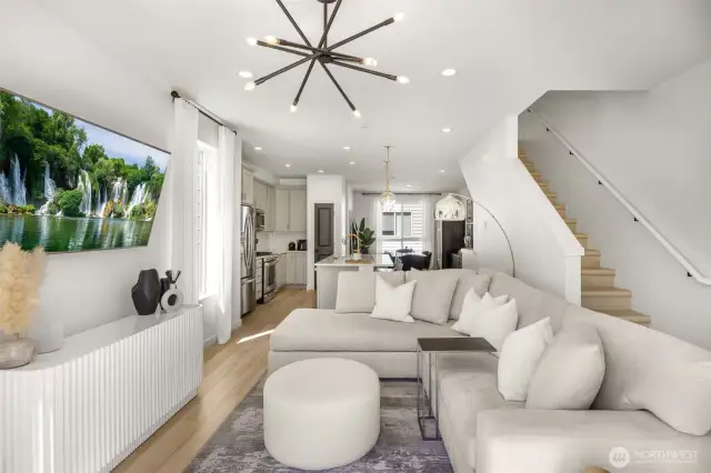 Corner facing living room with large windows and patio access.