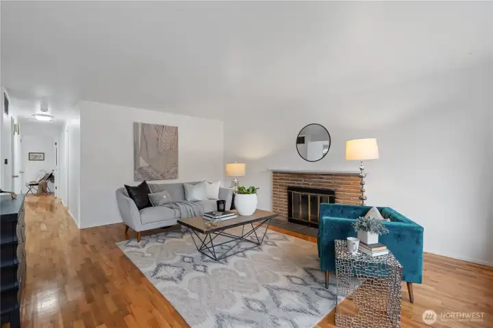 Step inside to this inviting and warm living room with all new interior paint, gleaming refinished oak hardwood flooring, newer 2023 roof and a cozy wood-burning fireplace.