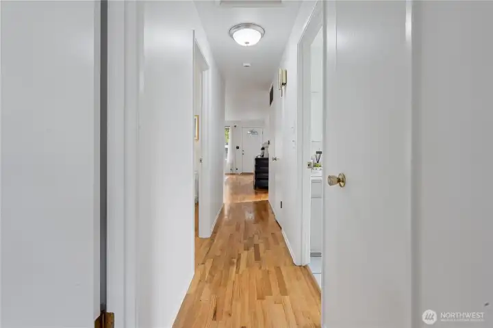 Sparkling refinished oak hardwood flooring extends throughout the living room, the hallway and all of the bedrooms.