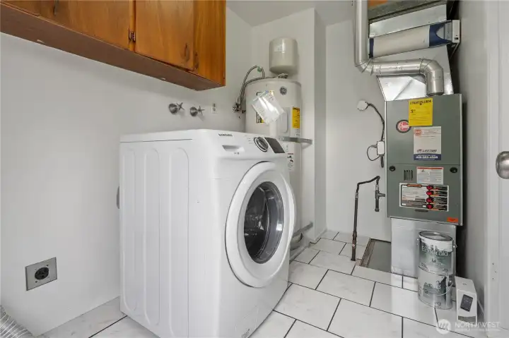 Past the kitchen is the mudroom with convenient built-in shelving for additional storage, ceramic tiled flooring and a side door for easy backyard and driveway access.