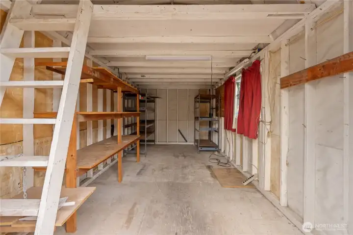 The oversized storage shed comes with convenient power, shelving and a ladder to the overhead storage unit.