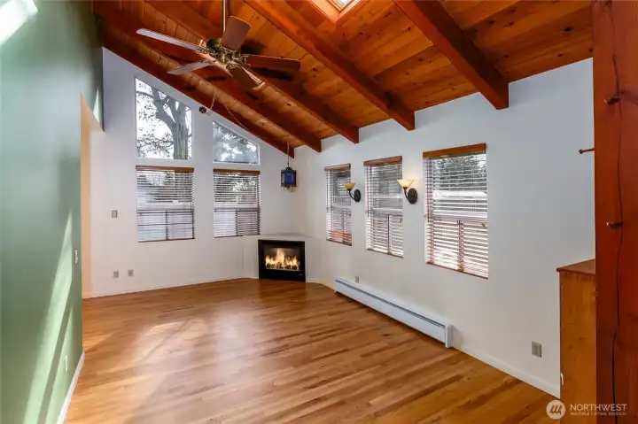 Propane fireplace under a valuted beam ceiling.