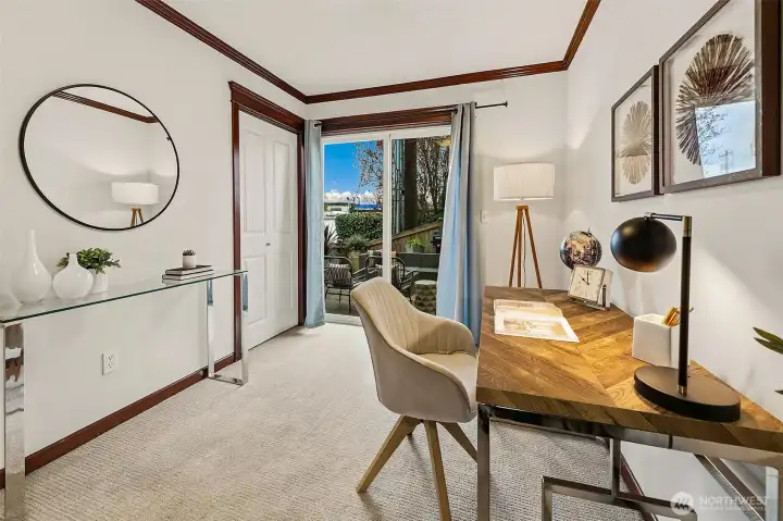 Entry floor bedroom, staged as an office. This room has direct access to the private patio.