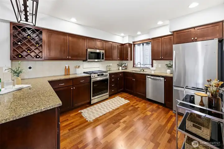 Large kitchen is open to the living room. It features newer appliances and plenty of cabinets and counter space.