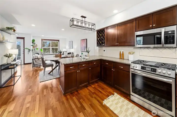 Large kitchen is open to the living room. It features newer appliances and plenty of cabinets and counter space.